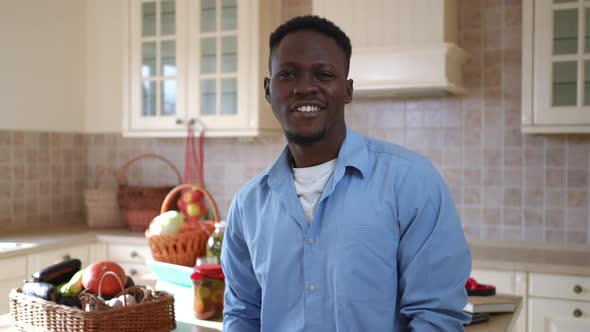 Medium Shot Portrait of Satisfied African American Young Man Looking Back at Marinated Conserved