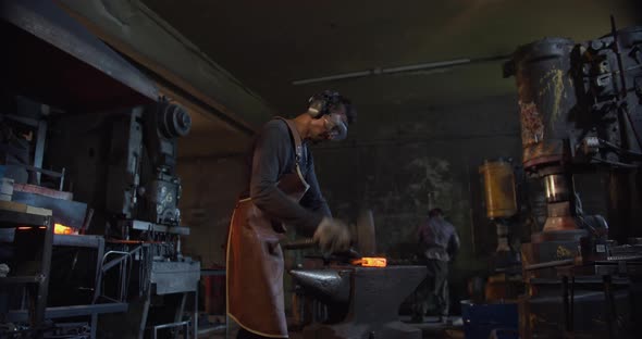 Blacksmith's Powerful Blow To Metal