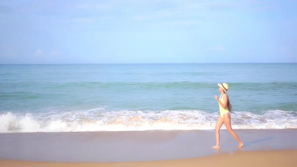 Asian woman enjoy around beautiful beach sea ocean