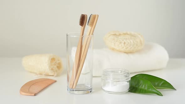 Woman Hand Take Bamboo Wooden Toothbrush From Glass in Bathroom