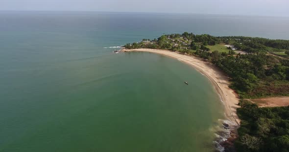 Aerial view of the African coastline of Mermaids Bay in San Pedro Ivory Coast showing trees and resi