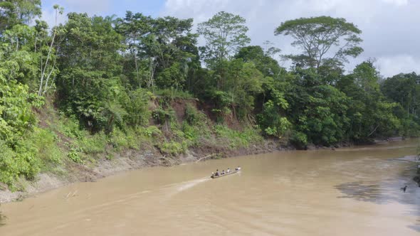 Top view, following a wooden canoe in a river in the amazon of South America