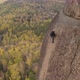 A Man Climbs a Rock with a Wonderful View of the Autumn Forest - VideoHive Item for Sale