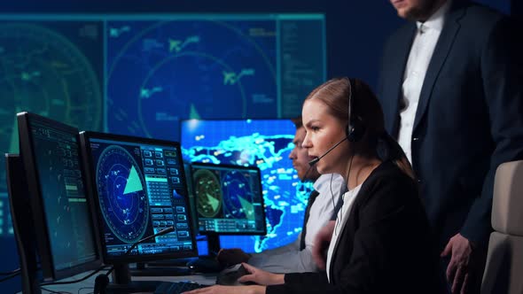 Workplace of the air traffic controllers in the control tower. Team of professional officers.