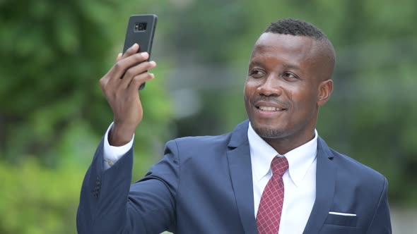 Young Happy African Businessman Taking Selfie Outdoors