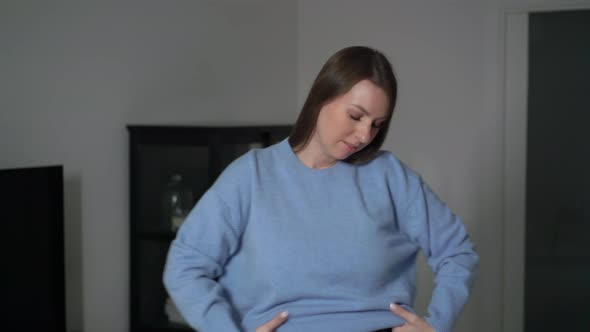 Young Woman Put on Blue Casual Pullover Sweater