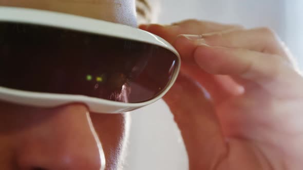 Young man using the virtual reality video glass