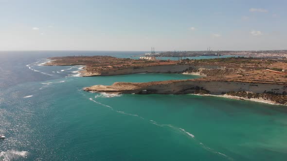 Aerial drone video from eastern Malta, Marsaxlokk area, Il-Hofra l-Kbira bay.