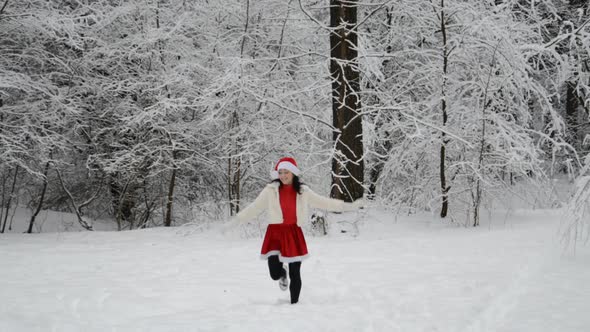 A Girl in a Winter Forest Is Jumping for Joy and Happiness in the Snow