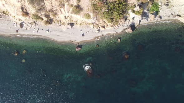 Aerial View From Above on Calm Azure Sea and Volcanic Rocky Shores