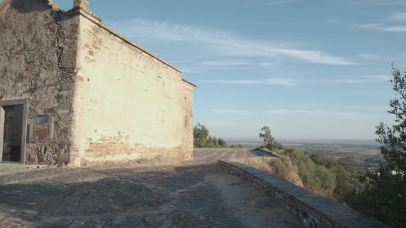 Pan of a close view of the Monsaraz abandoned church.