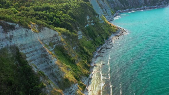 Aerial View of Rocky Coastline Down Blue Sea Deep White Cliffs