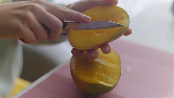 The Woman Cleans Cuts and Eats Mango