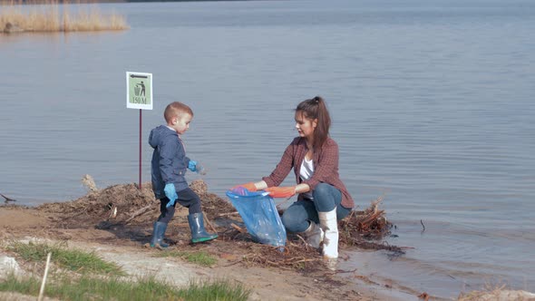 Environmental Problems Solutions, Boy Helps Woman Volunteer Activist Clean Up Dirty River Waterfront