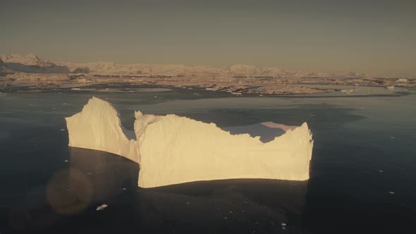 Aerial Flight Over the Sunlit Iceberg. Antarctica.