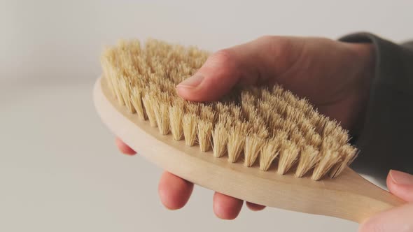 Wooden massage brush for dry massaging and scrubbing of the skin and anti-cellulite contours