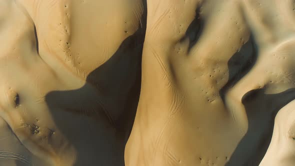 Aerial view above of strong shadows created by desert landscape, U.A.E.