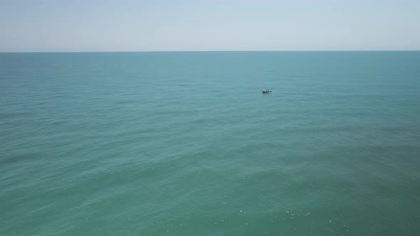 Single small fishing boat among vast water empty water