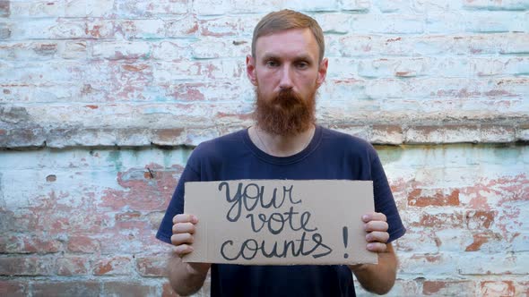 Man shows cardboard with Your Vote Counts sign Make the political choice Presidential elections 4K