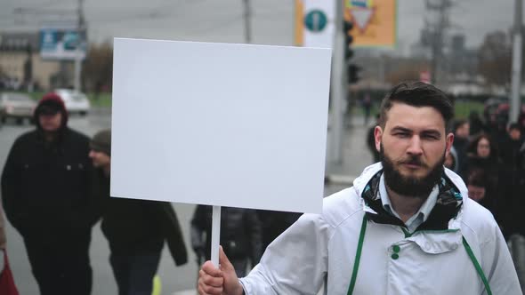 Man with Advertising Blank Banner Walking on Streets