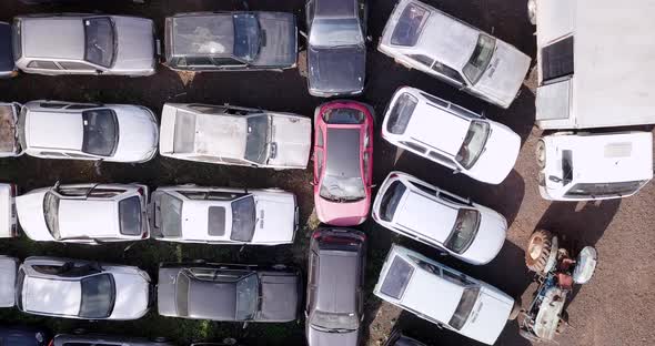 Abandoned vehicles, rotting, decaying, falling apart, graveyard of cars. Aerial camera.