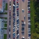 A Drone Flies Over a Road with Moving Cars. Forest and High-Rise Buildings - VideoHive Item for Sale