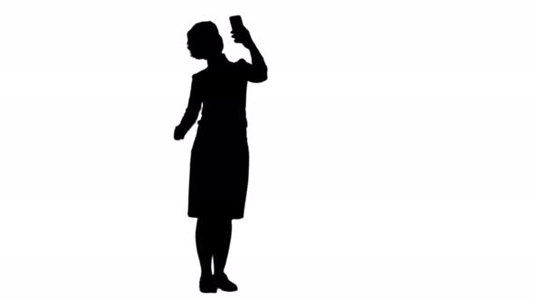 Silhouette Smiling Cute Woman Making Selfie Photo on Smartphone Track Matte