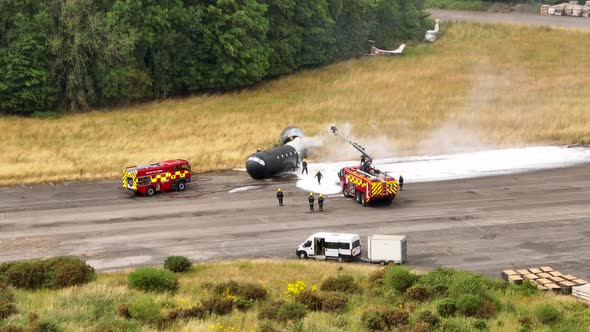 Firefighters Training to Tackle a Fire of a Dummy Aircraft
