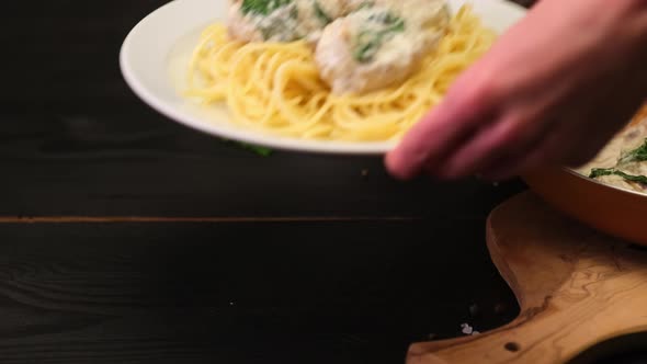 Portion of Delicious Meatballs with Spinach in a Creamy Sauce