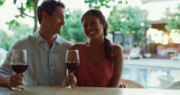 Couple Enjoying Glass of Wine at Luxury Resort