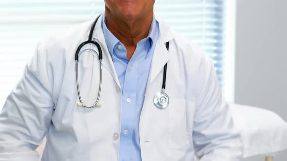 Portrait of doctor sitting in hospital