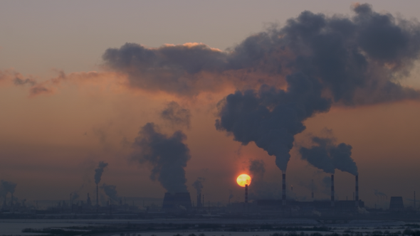 The Sun Sets over the Smoking Thermoelectric Power Plant