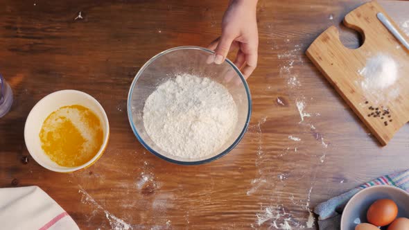 Hands Kneading Raw Dough on Table Flat Lay. Top View on Baker with Empanadas Cooking on Table