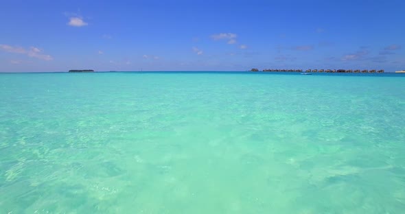 Aerial drone view of a woman floating and swimming on a tropical island