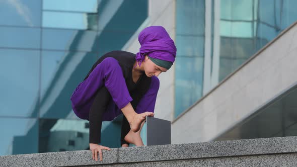 Young Strong Business Woman Islamic Muslim Student Stands in Balance Handstand Asana Acrobatic