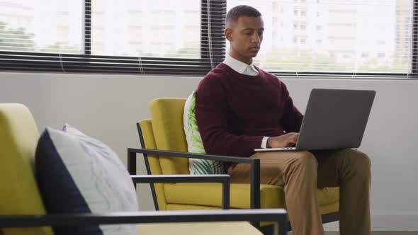 Mixed race man working on laptop