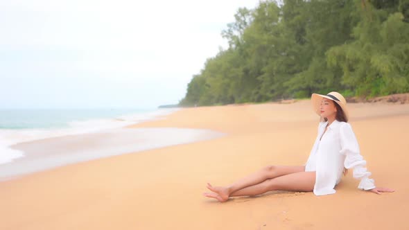 Asian woman enjoy around beautiful beach sea ocean