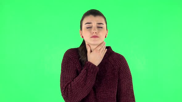 Girl Got a Cold, Sore Throat and Head, Cough on Green Screen at Studio. Green Screen