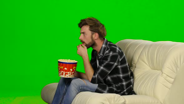 Man Eating Popcorn and Watching a Movie. Green Screen