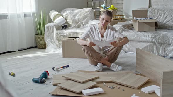 Confused Woman Assembling Furniture