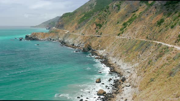 Nature Landscape with Winding Coastal Road at Green Pacific Ocean Waters  USA