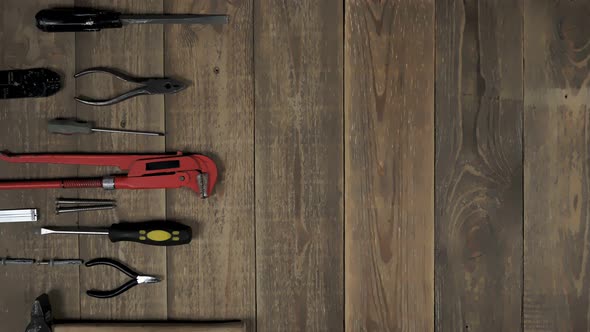 Animation of a Hand Tool for a Home Master on Wooden Background