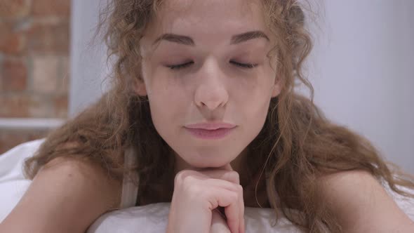 Young Female Face Lying in Bed