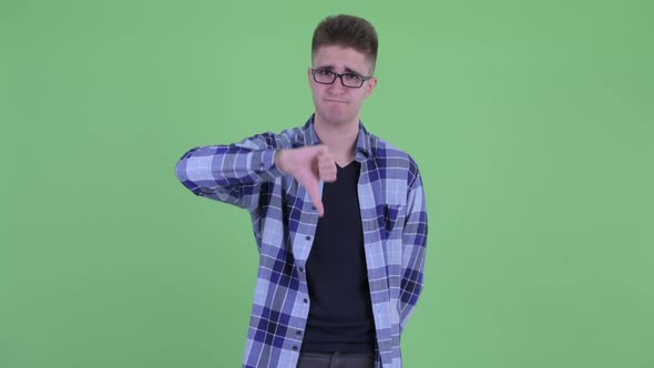 Sad Young Hipster Man Giving Thumbs Down