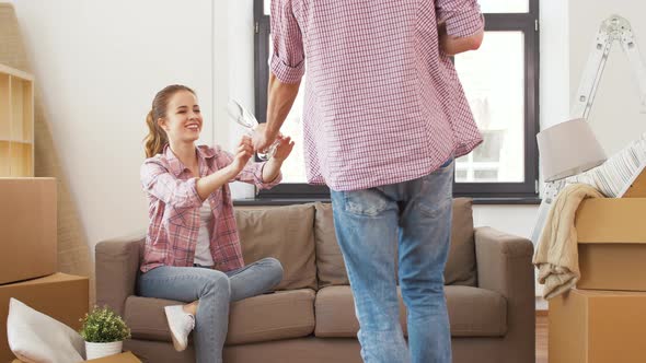 Couple Opening Bottle of Champagne at New Home