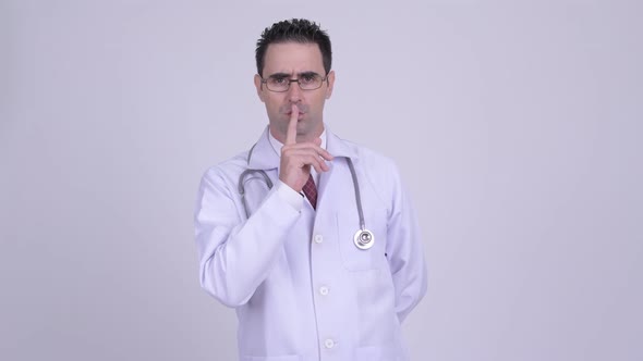 Serious Man Doctor with Finger on Lips