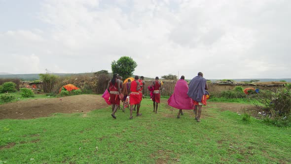 People walking in a Maasai village