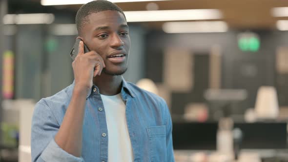 Young African American Man Talking on Phone