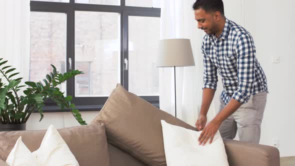 Indian Man Arranging Sofa Cushions at Home 45
