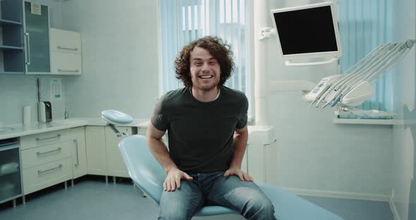 Young Man in a Dental Clinic Smiling Large in